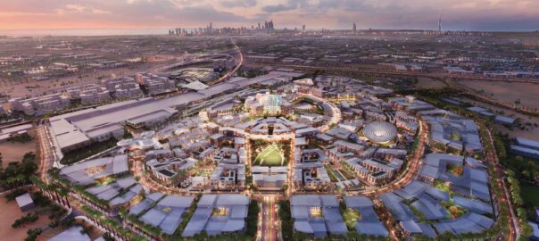 An aerial shot of a brightly lit Expo 2020 Dubai during sunset