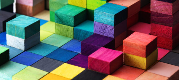 Multiple coloured wooden toy blocks to symbolise neurodiversity.