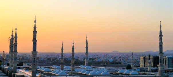 Sun rising above a cityscape in Saudi Arabia.