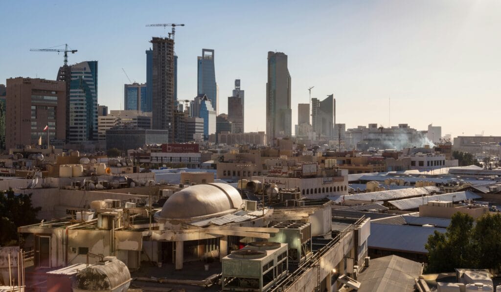 A city skyline showing skyscrapers and warehouses.