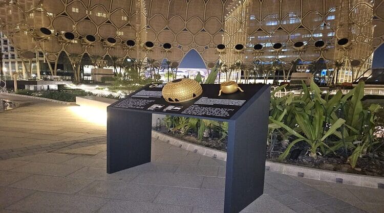 A medium shot of the interior of the Al Wasl Dome at Expo City Dubai at night time, with a Tactile Braille Map board developed by Direct Access in the center of the image.