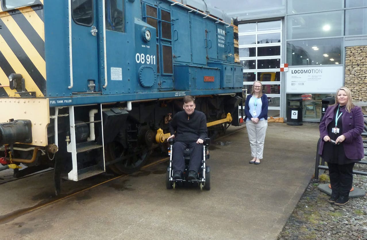 Tom Morgan at Locomotion Museum next to an old fuel tank filler