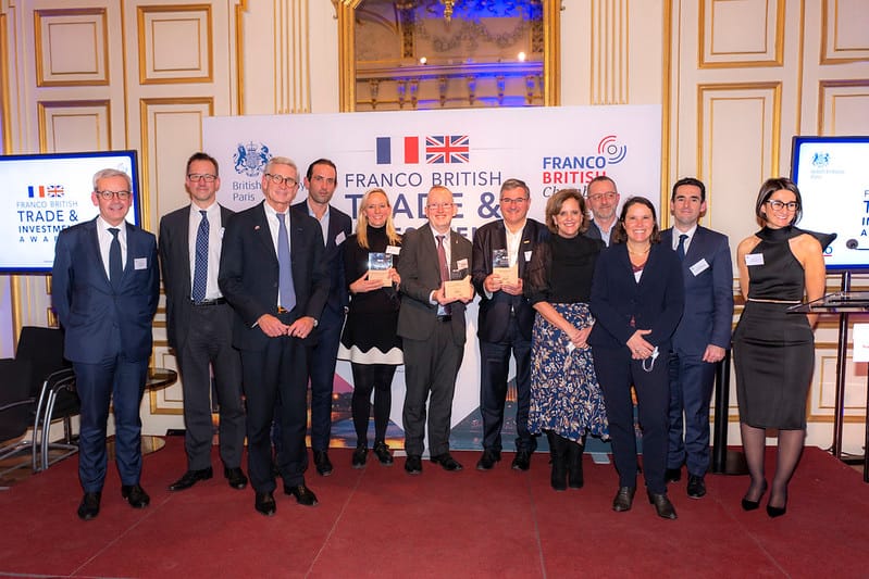 Steve Dering at Franco British Chamber Awards surrounded by a mixed group of other recipients, all well dressed in suits and dresses.