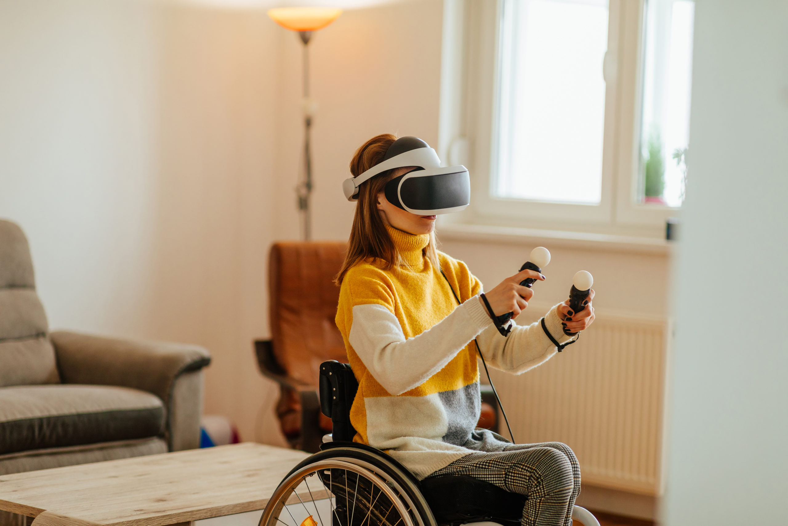 Female in wheelchair wearing vr glasses at home