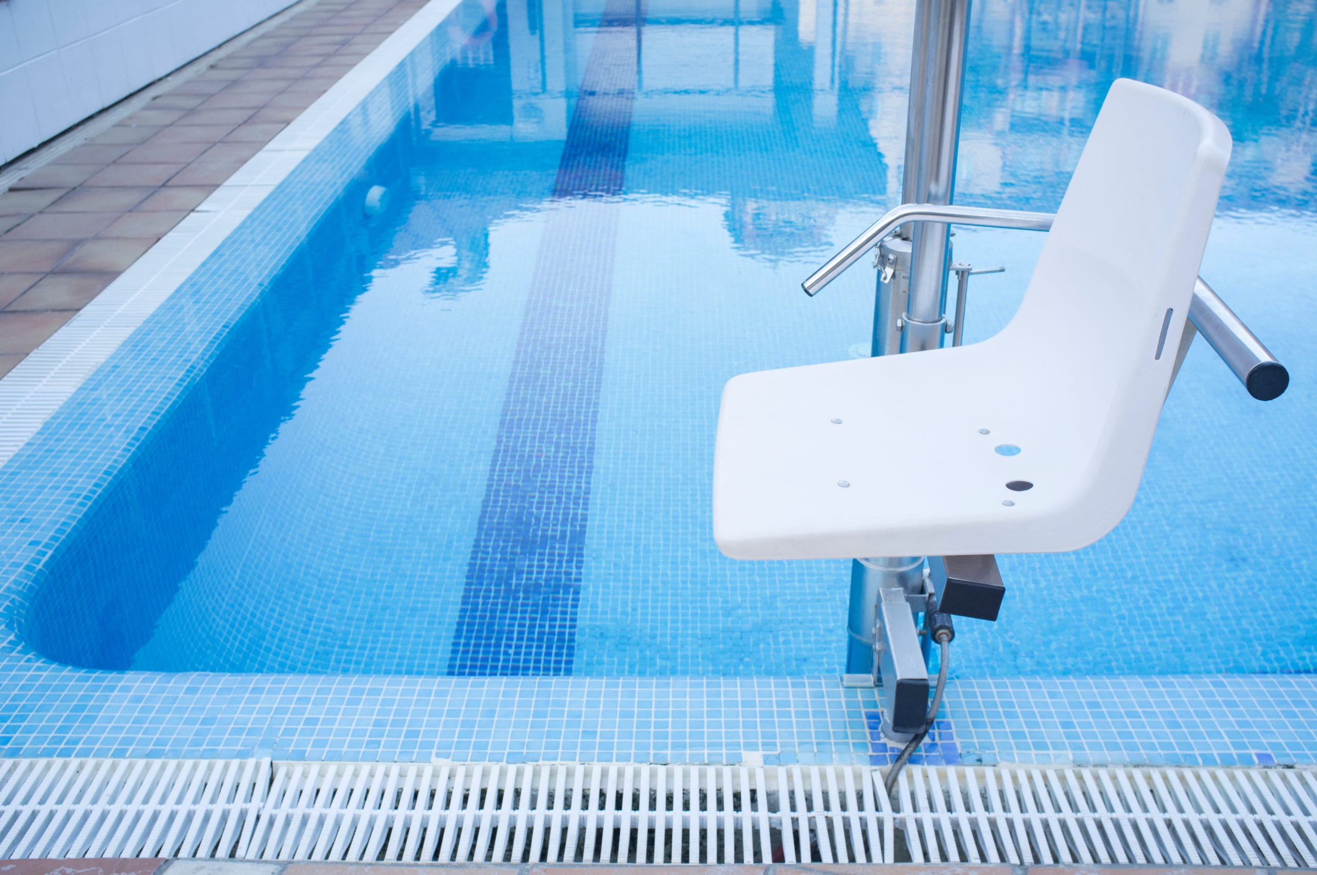 Swimming pool lift seat for disabled people access to a still swimming pool