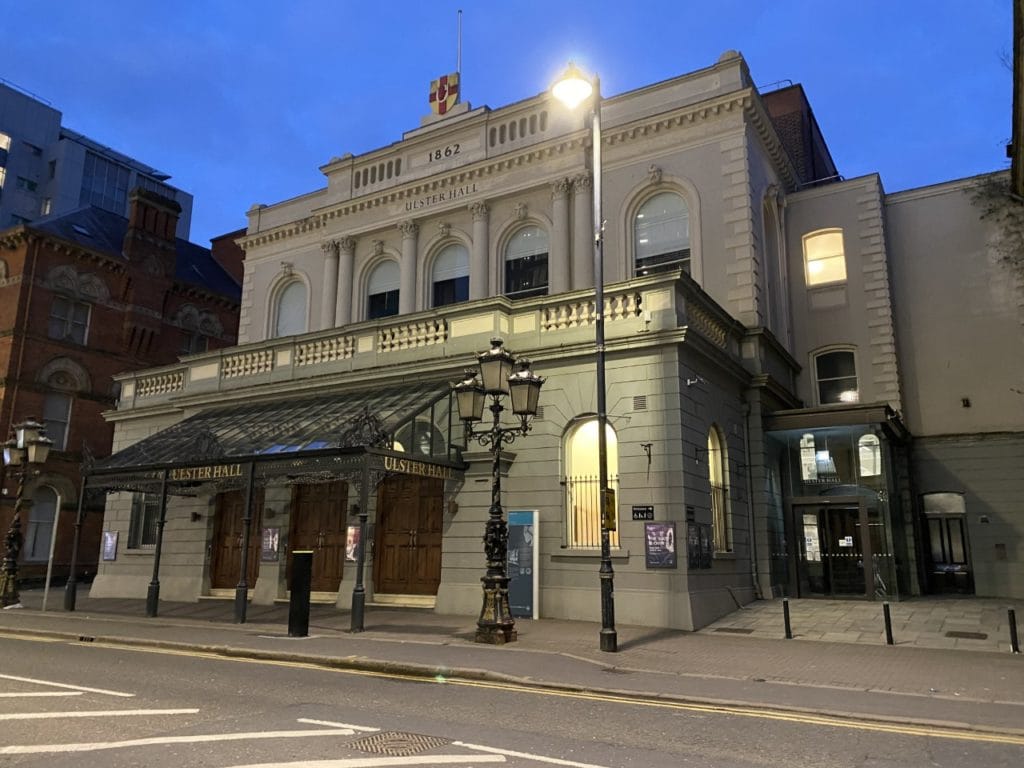 Ulster Hall exterior at night time lit by a street lamp