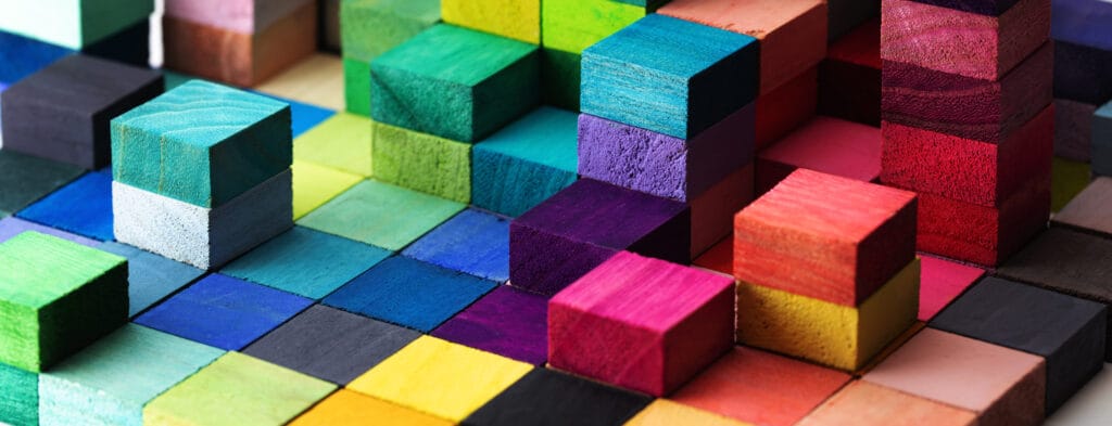A spectrum of stacked multi-colored wooden blocks.