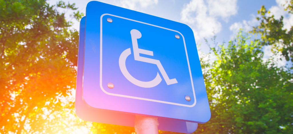 A blue accessible parking sign featuring the international symbol of access.