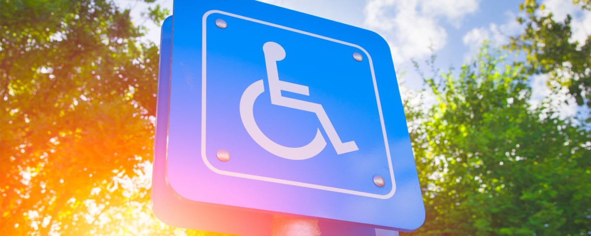 A blue accessible parking sign featuring the international symbol of access.