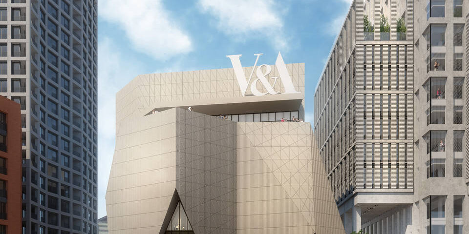 A proof of concept photo of the V and A East museum, showing a large, baige building that looks like an upside down crown. A large V and A sits on the top. Outside crowds of people commute on the open plan path space. At the forefront, a set of stairs lead down to a nearby canal with a red, white, and blue coloured boat passing by.