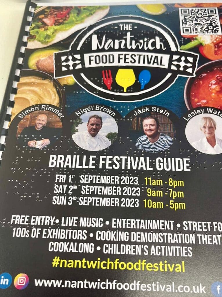 A close up of a Braille festival guide for the Nantwich Food Festival 2023. Photos of various guests are on the cover, including Simon Rimmer, Nigel Brown, Jack Stein and Lesley Waters.