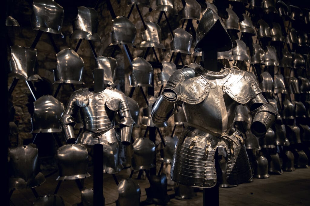 Suits of armour and a display of breastplates in the Armoury of the Tower of London.