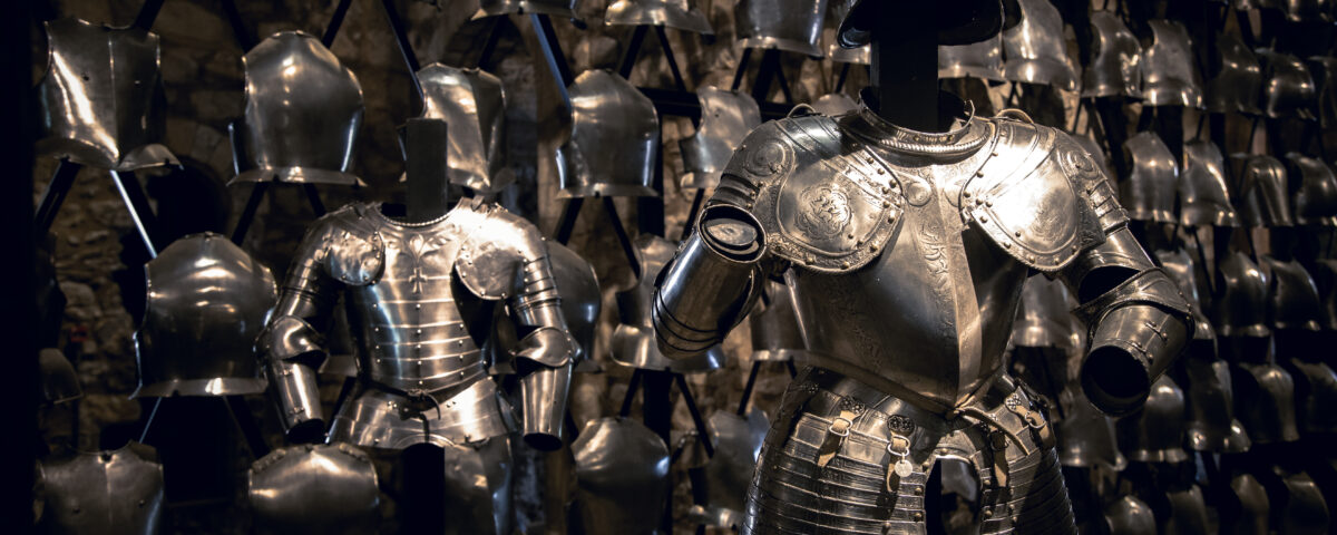 Suits of armour and a display of breastplates in the Armoury of the Tower of London.