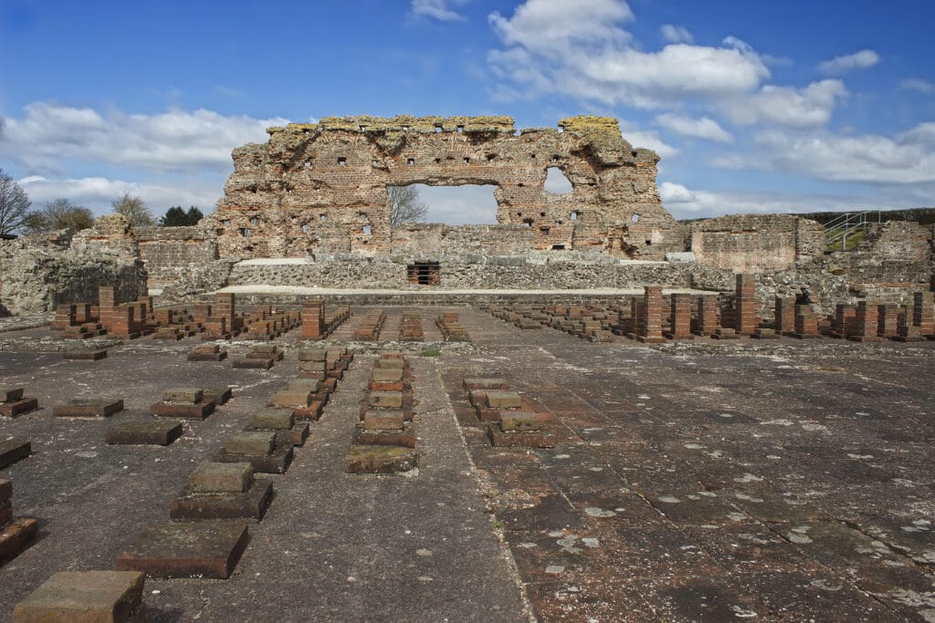 A wide shot photograph of the Old Work, an incomplete wall structure which are part of the sole remains of a former Roman City in Wroxeter, England.