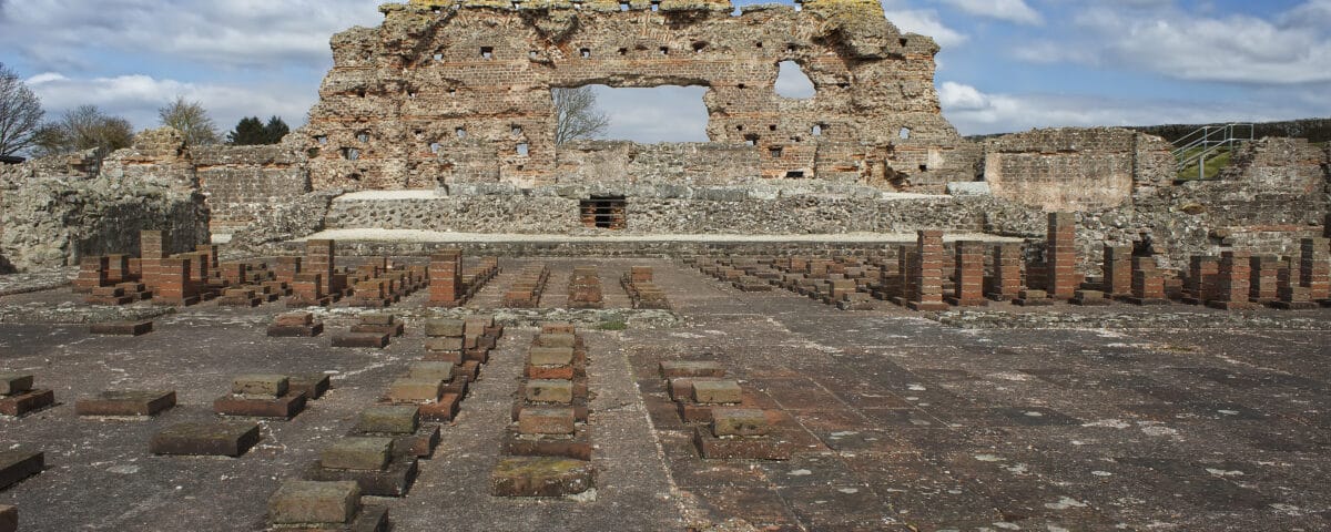A wide shot photograph of the Old Work, an incomplete wall structure which are part of the sole remains of a former Roman City in Wroxeter, England.