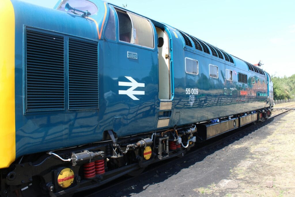 A close up photograph of a large blue train.