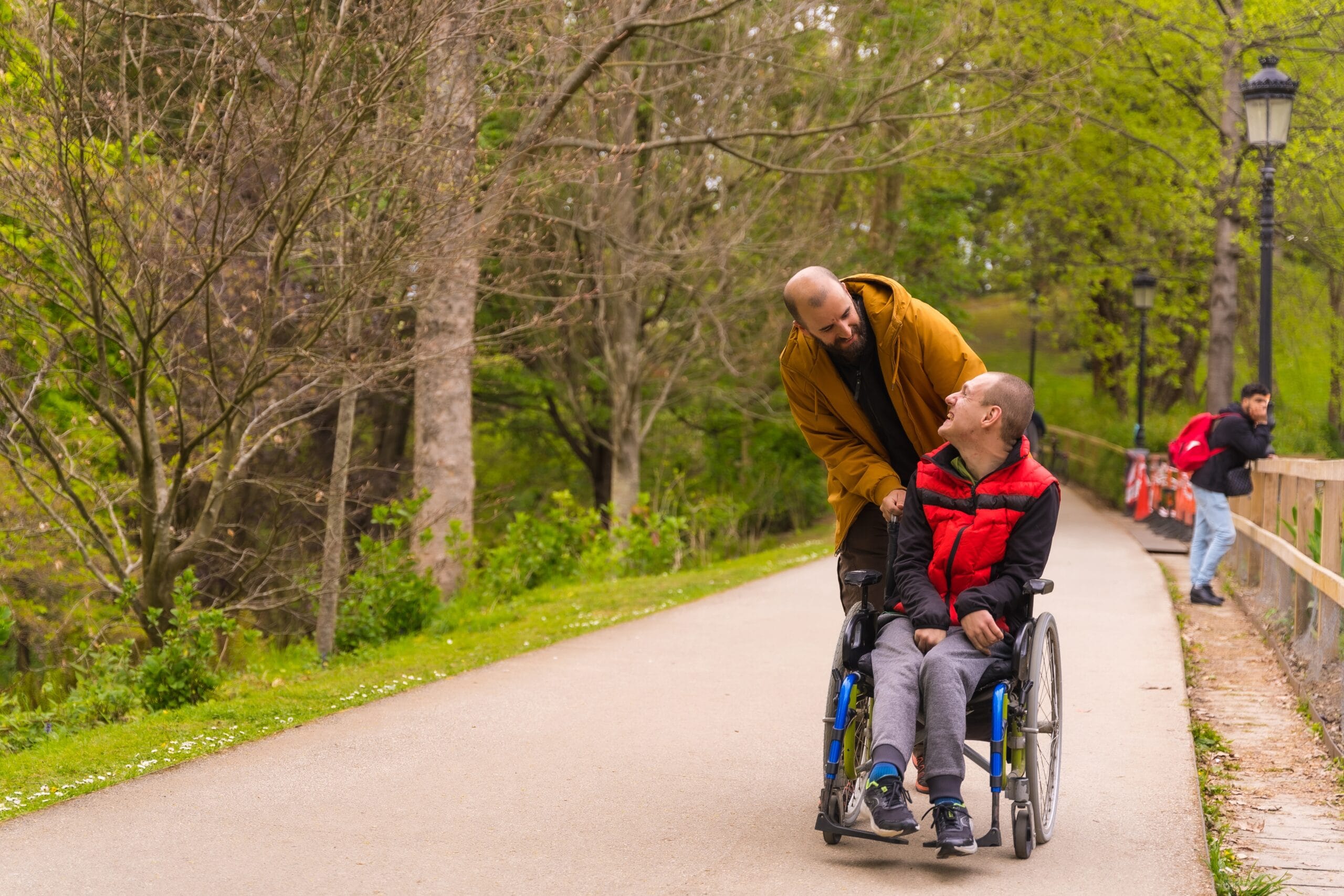 A,Person,With,A,Disability,In,A,Wheelchair,Being,Pushed