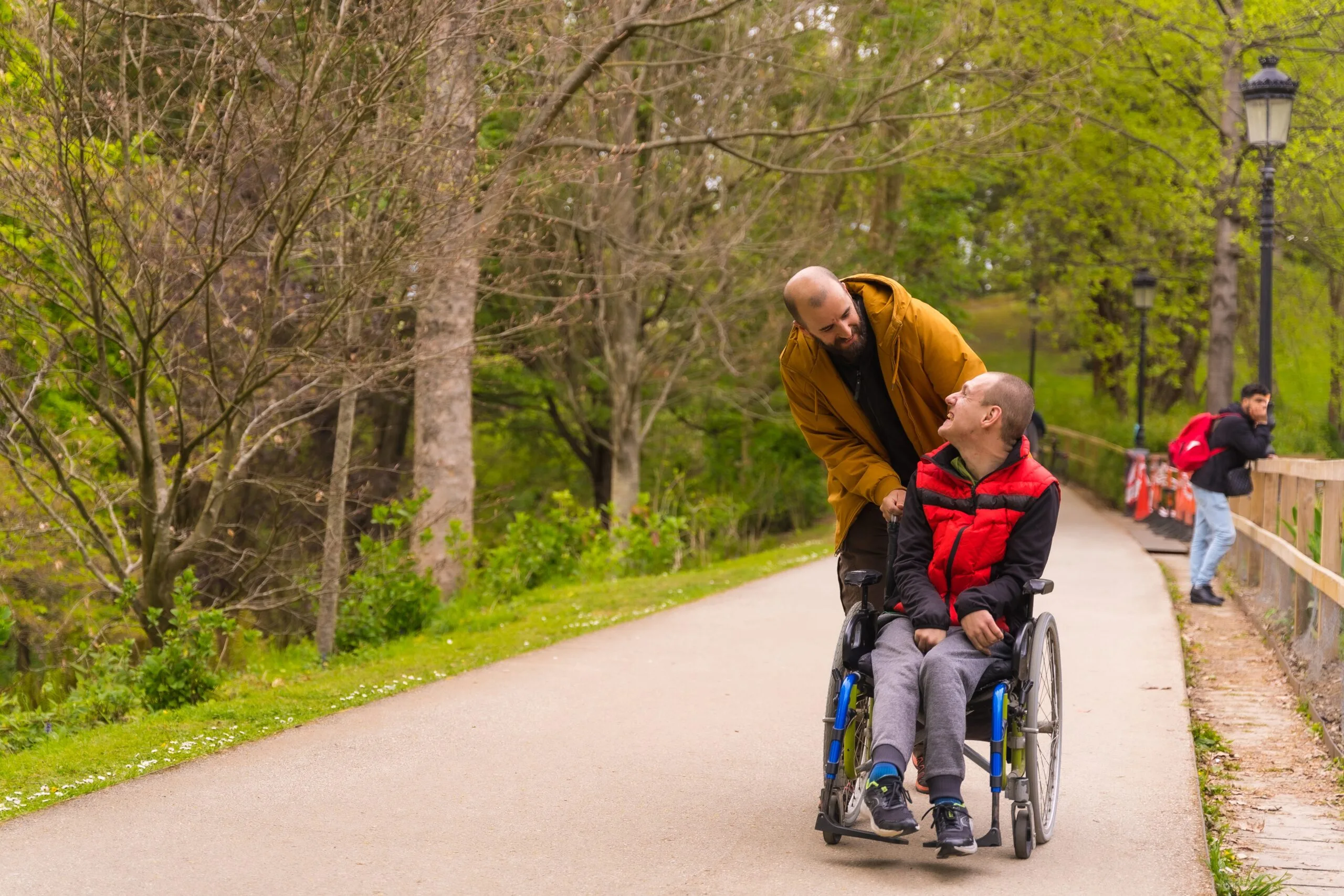 A,Person,With,A,Disability,In,A,Wheelchair,Being,Pushed