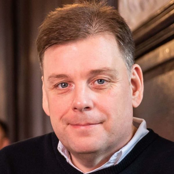 A close-up photograph of Direct Access Consultant Tom Morgan smiling.