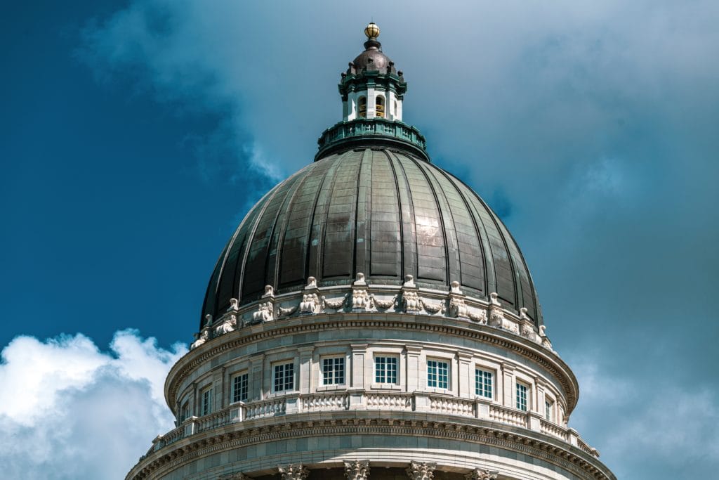The Utah State Capitol Building with blue skies and clouds in the backdrop.