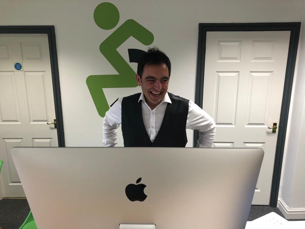 Steven Mifsud, founder of Direct Access smiling while delivering a talk on an Apple iMac in the Direct Access offices