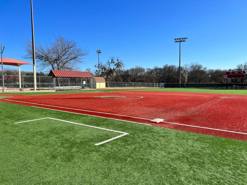 A baseball field in a Texas park on a sunny day.