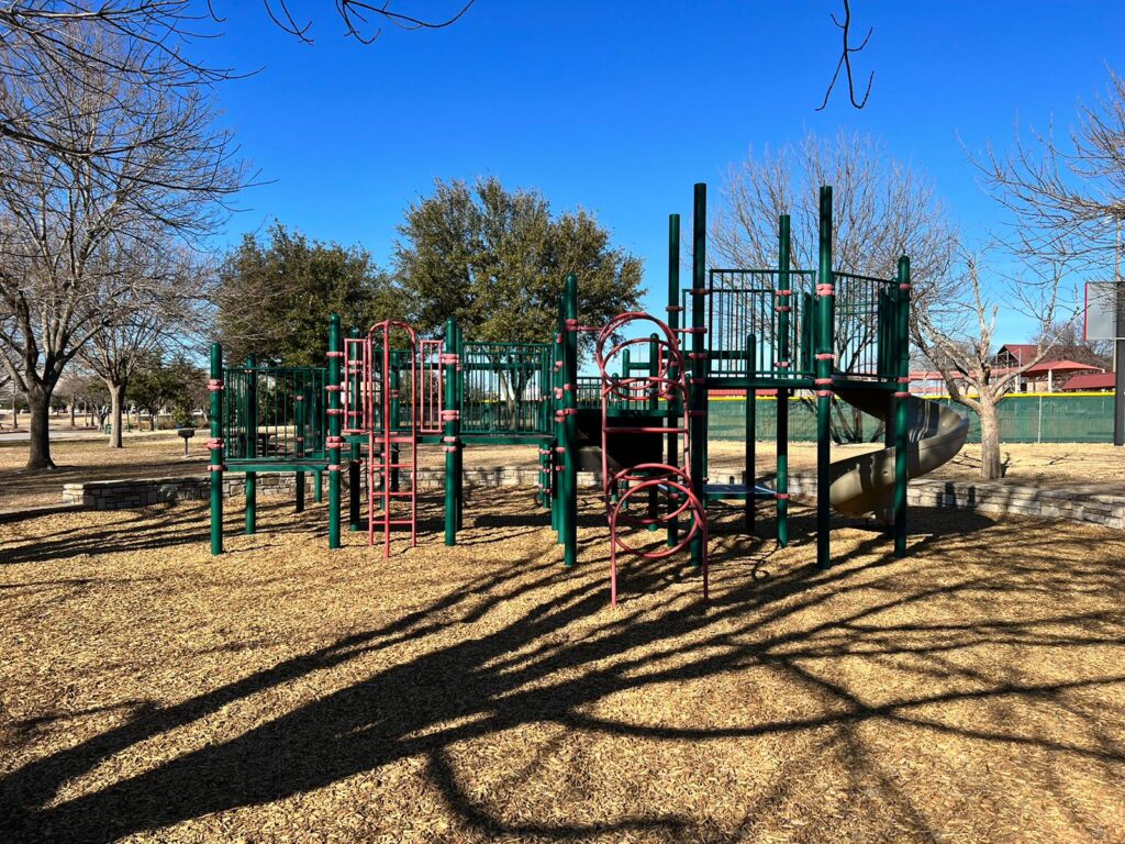 A children's park with various slides and climbing frames in Allen, Texas.
